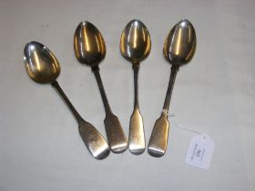 Four silver serving spoons