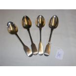 Four silver serving spoons