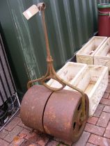 A vintage metal garden roller