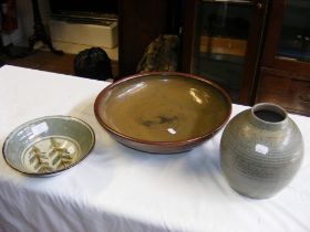 A Poole Pottery ribbed vase, together with two stu