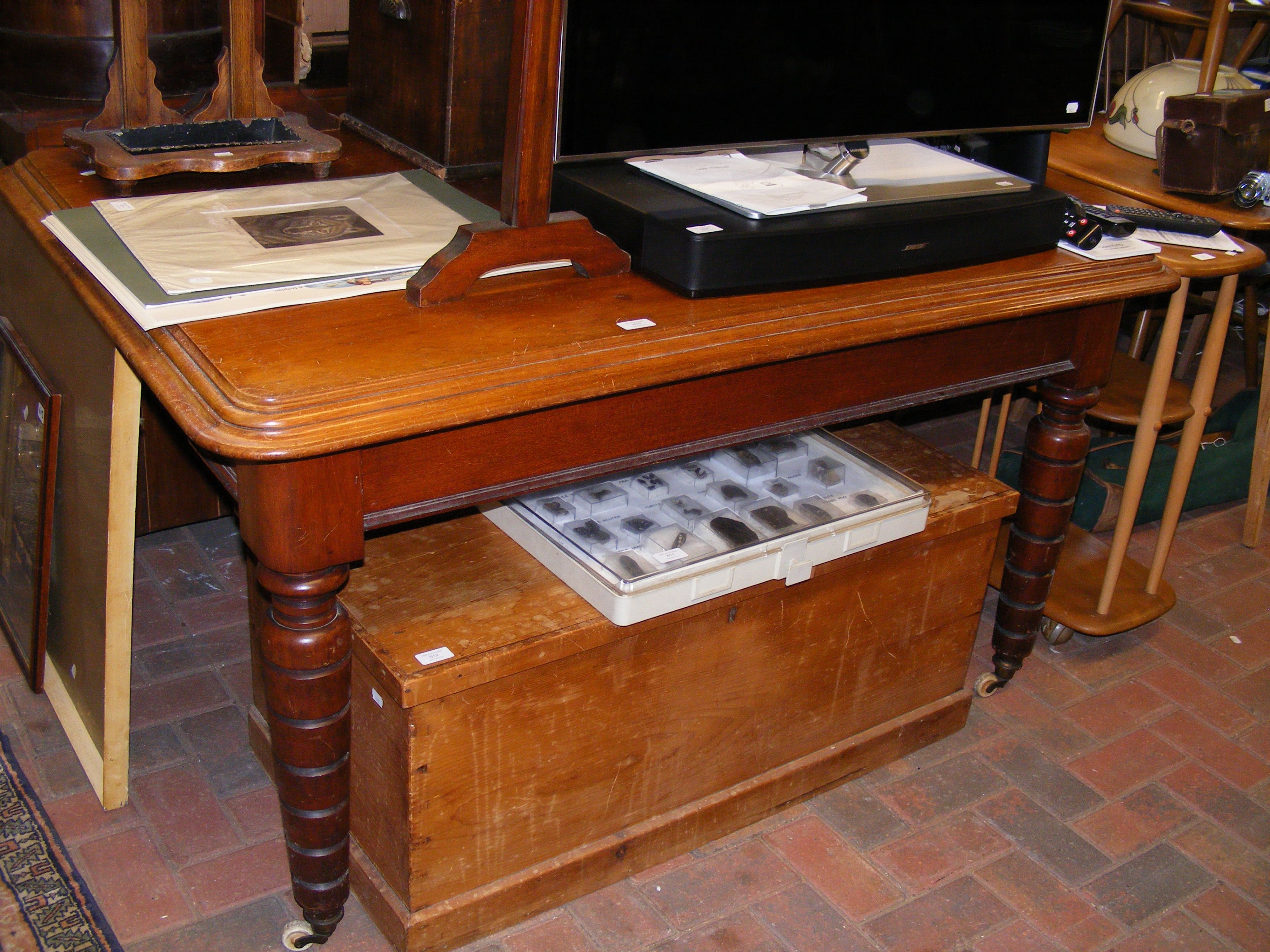 A mahogany rectangular dining table on castor supp