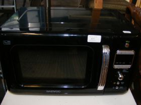 A Daewoo microwave in black