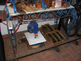 A wrought iron garden potting table painted blue,