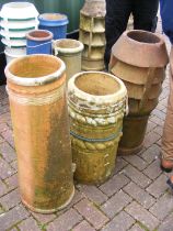 Three chimney pots of varying shape and size