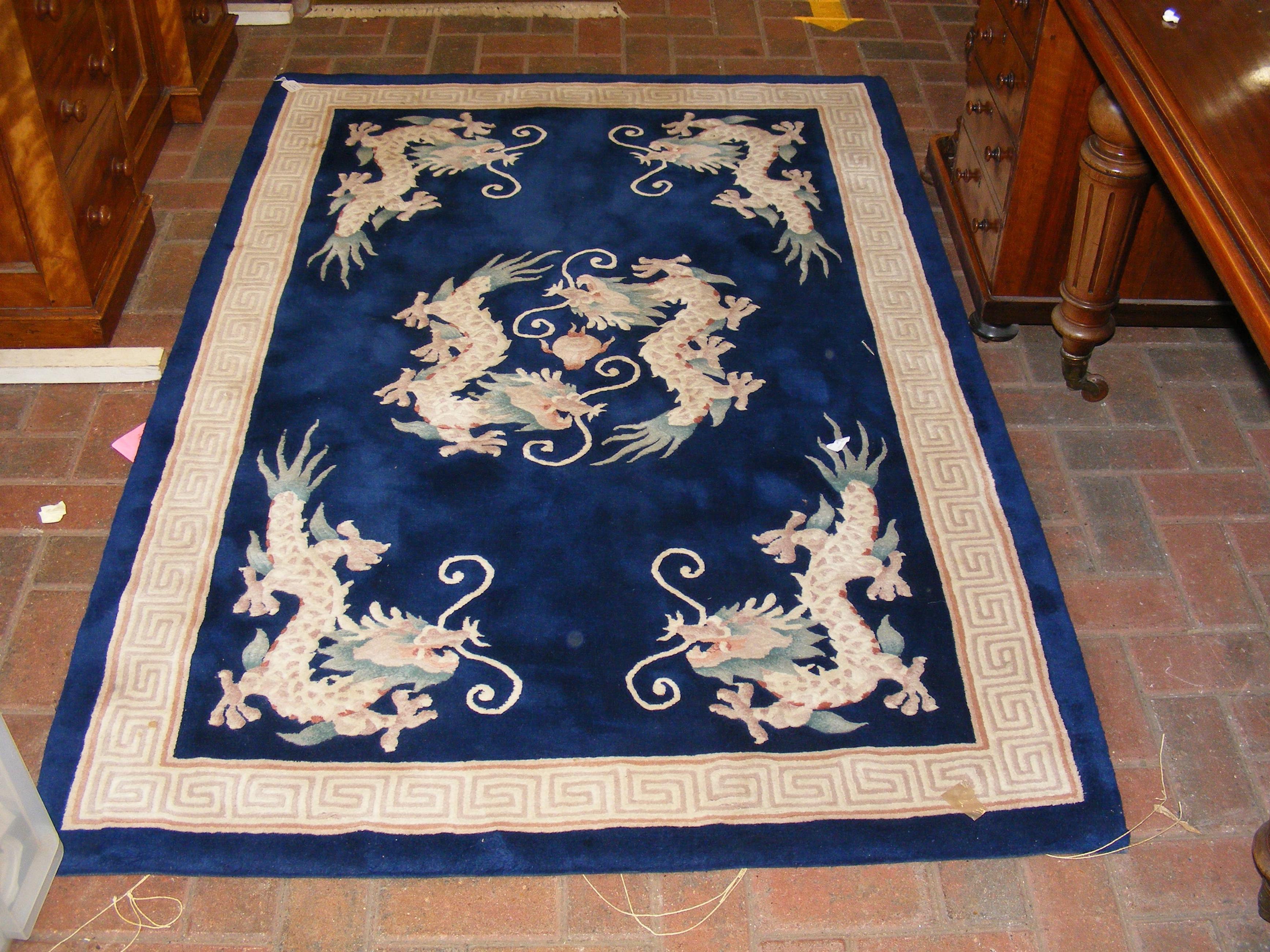 A Chinese rug with dragon design - 185cm x 124cm