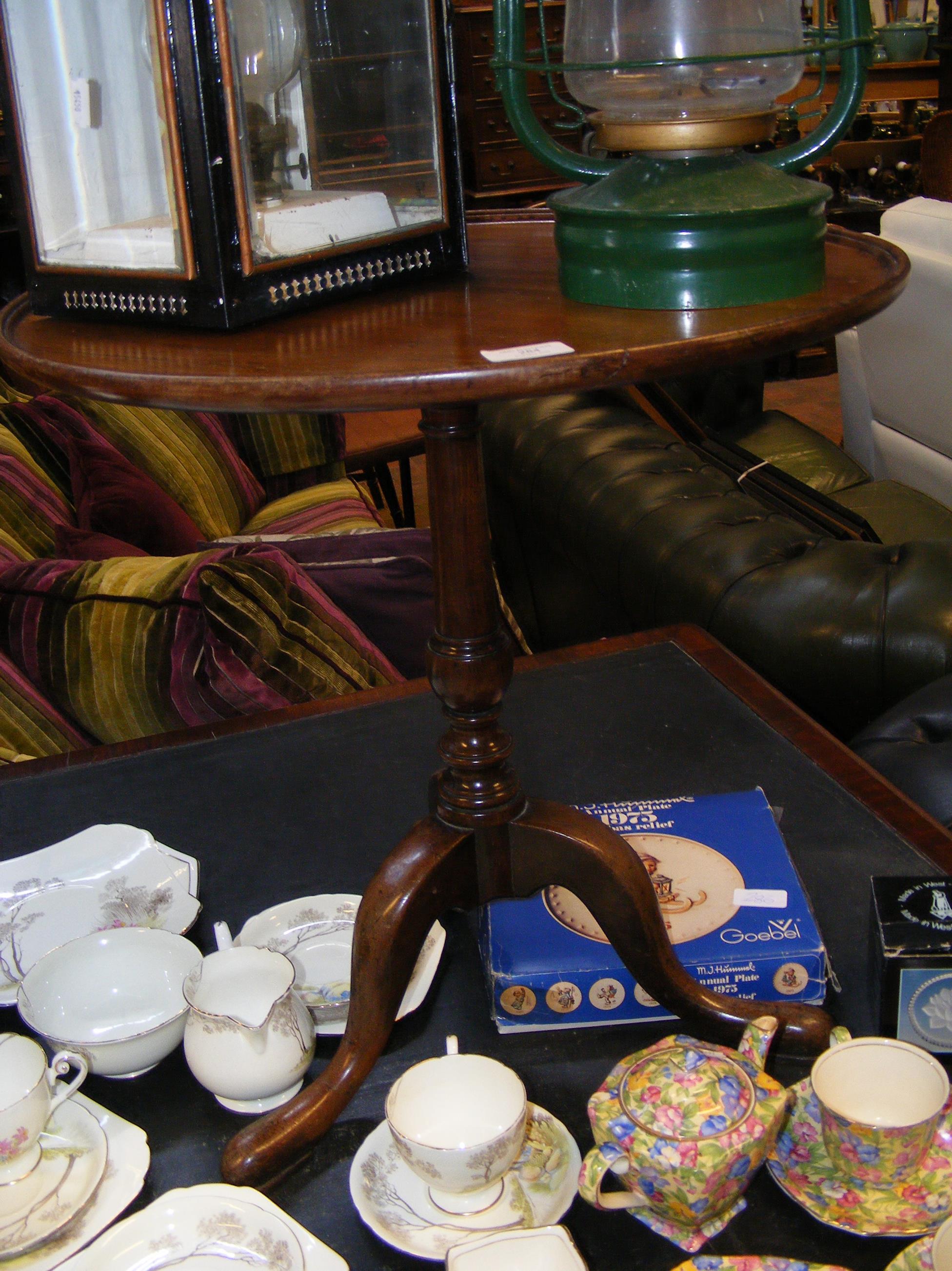 An antique circular mahogany wine table on tripod