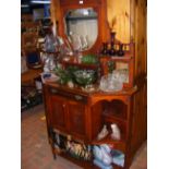 A mahogany chiffonier with bevelled shield shaped