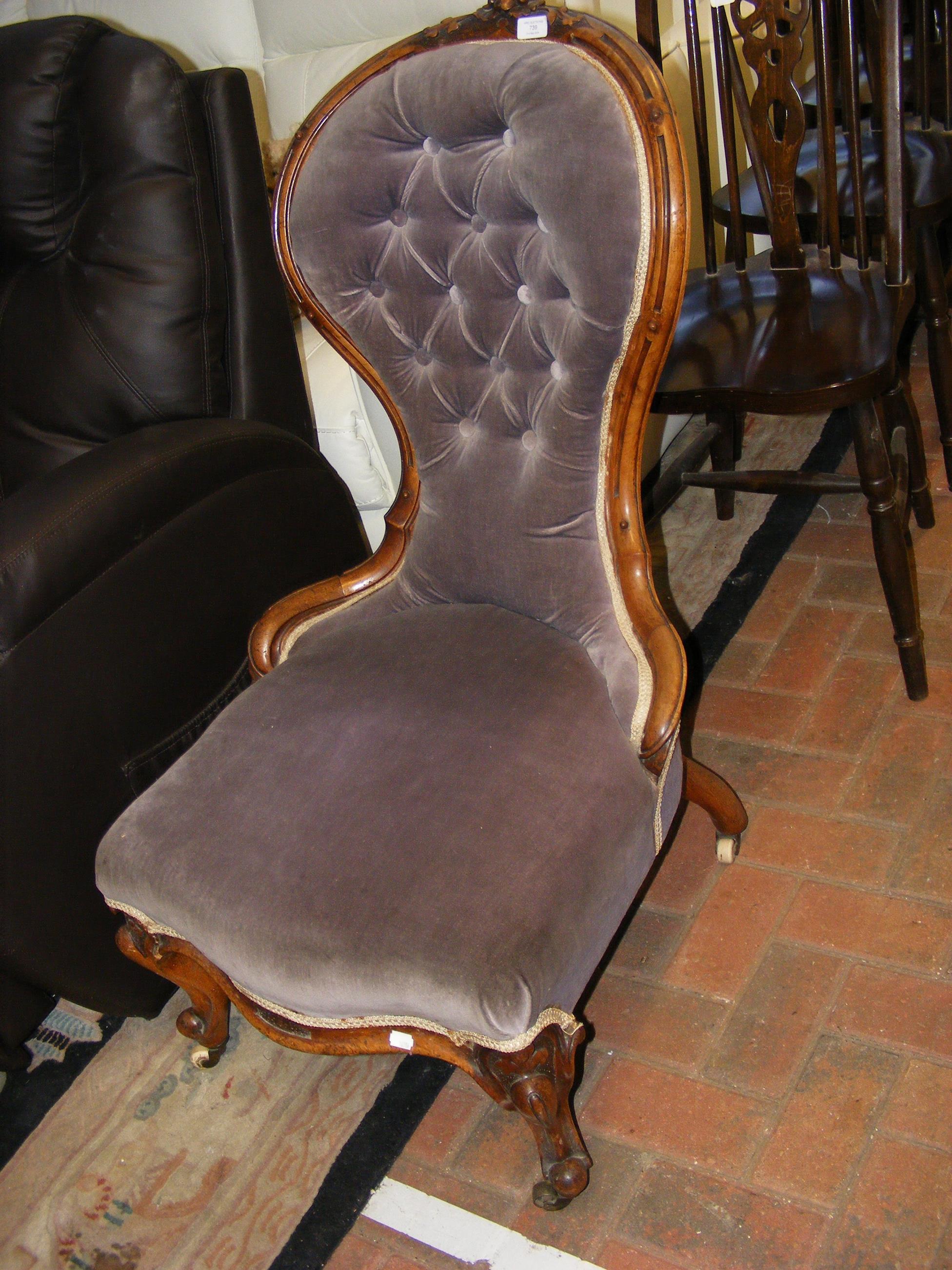 A Victorian button back nursing chair on cabriole