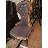 A Victorian button back nursing chair on cabriole