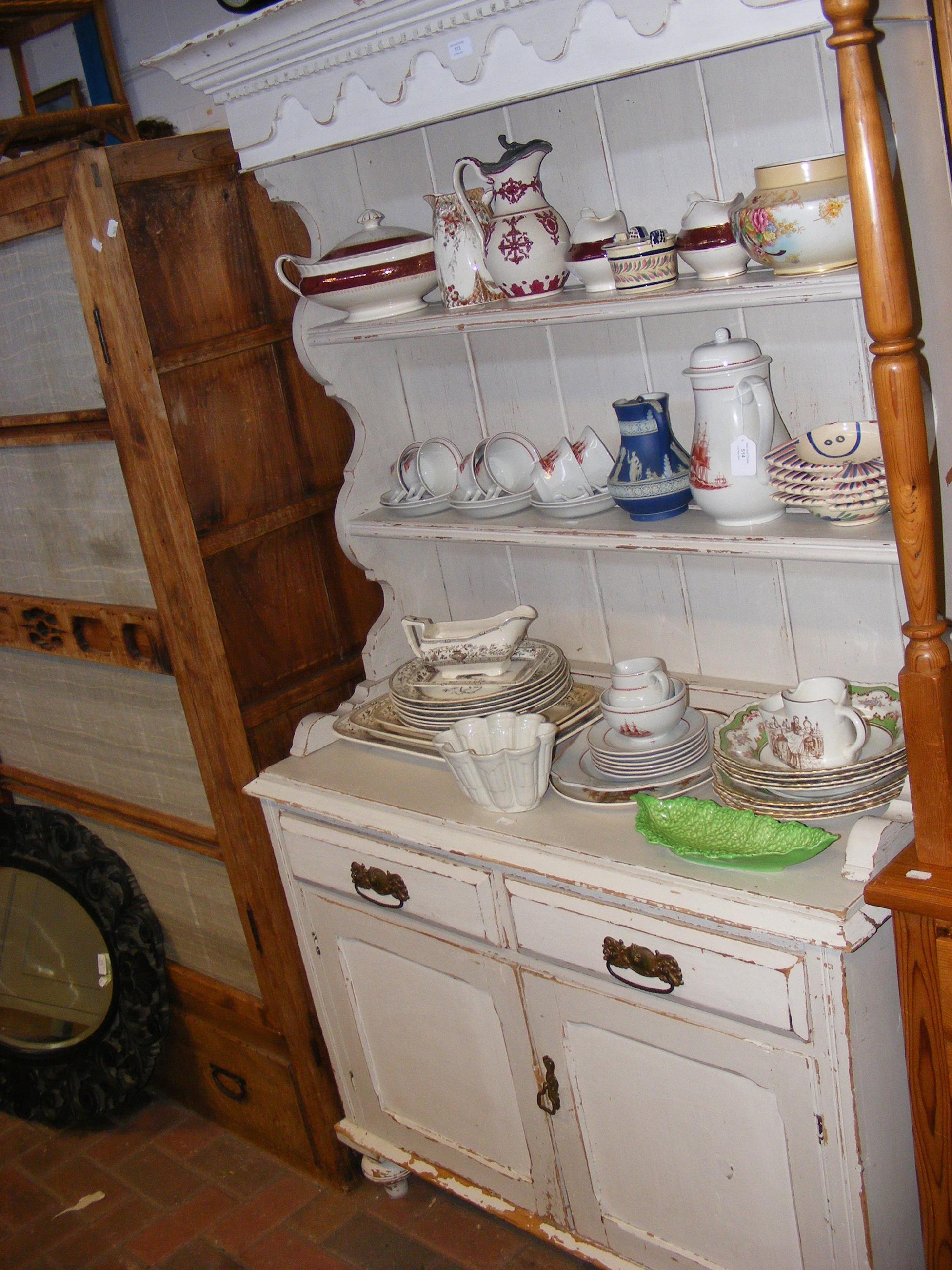 An antique painted pine kitchen dresser with plate