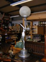 An Art Deco style table lamp of woman holding orb