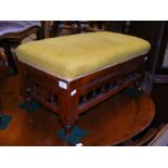 An antique stool with cushioned seat