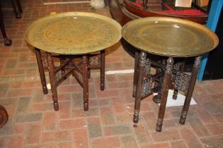 A folding Middle Eastern brass top table and one o