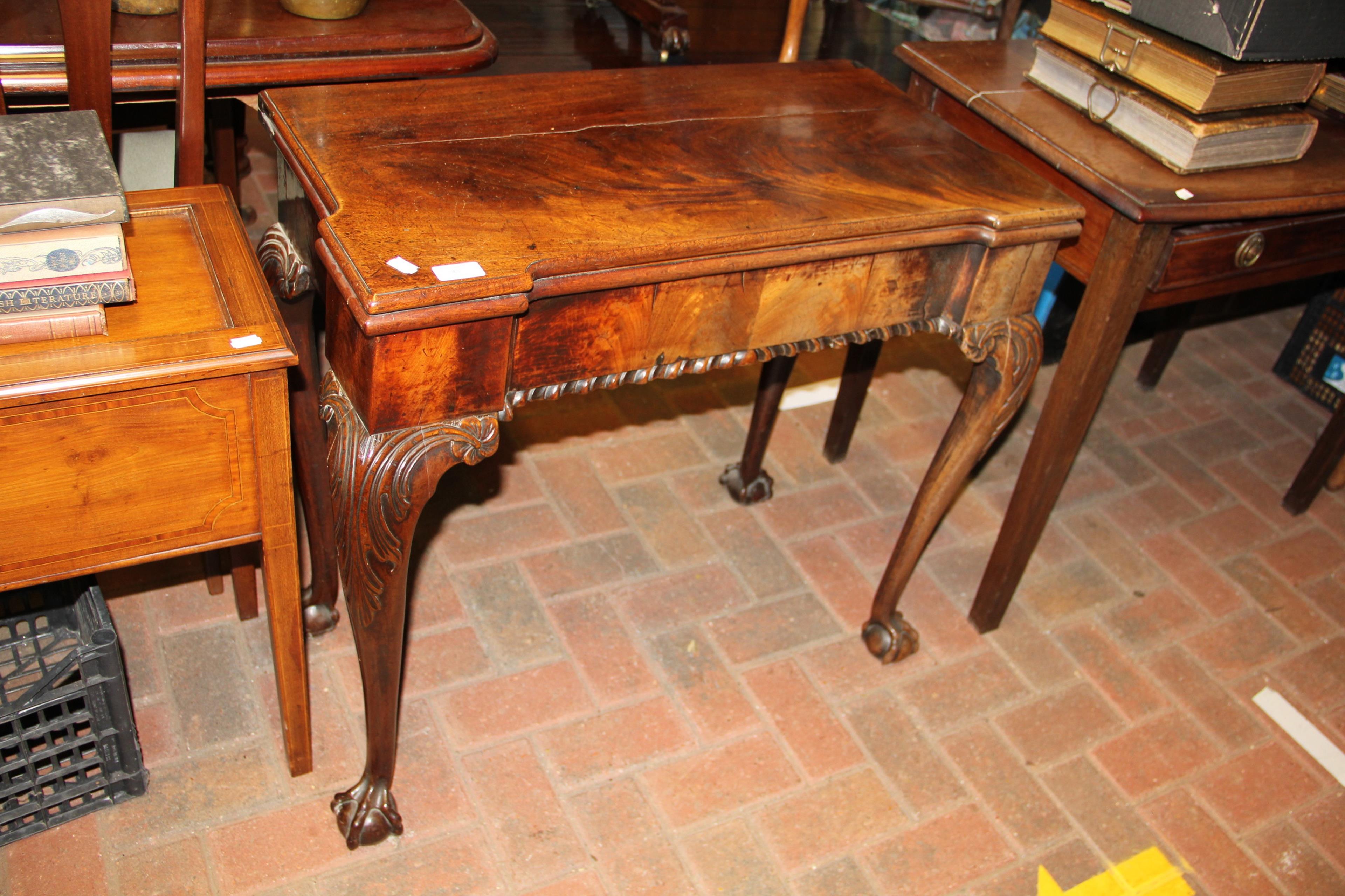 A Georgian mahogany fold-over tea table on cabriol