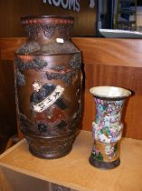 An oriental vase with fighting Samurai scene and m