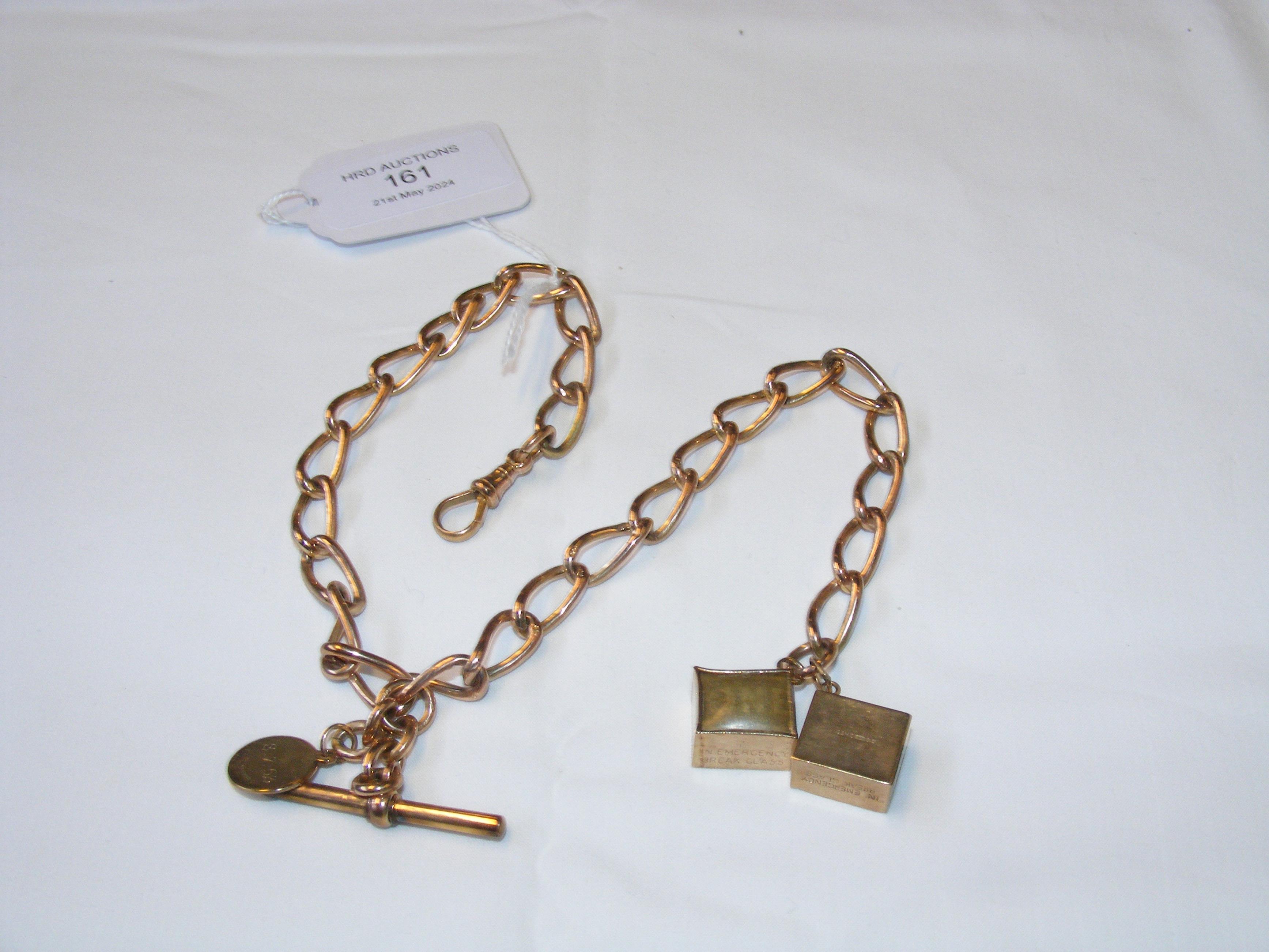 A 9ct watch chain with two charms