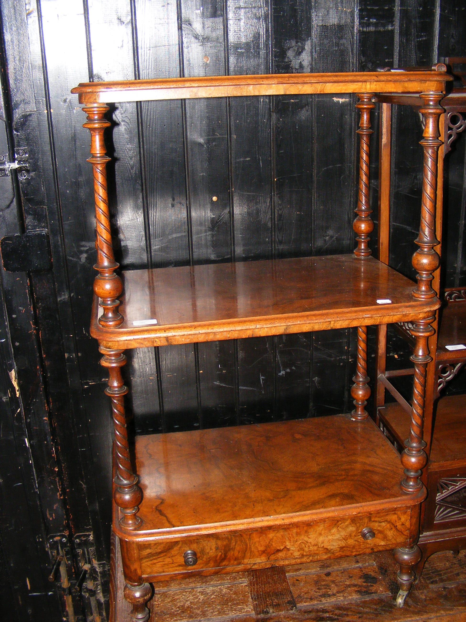 A three tier Victorian walnut whatnot with single drawer to base on castors