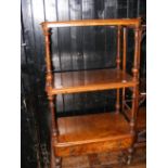 A three tier Victorian walnut whatnot with single drawer to base on castors
