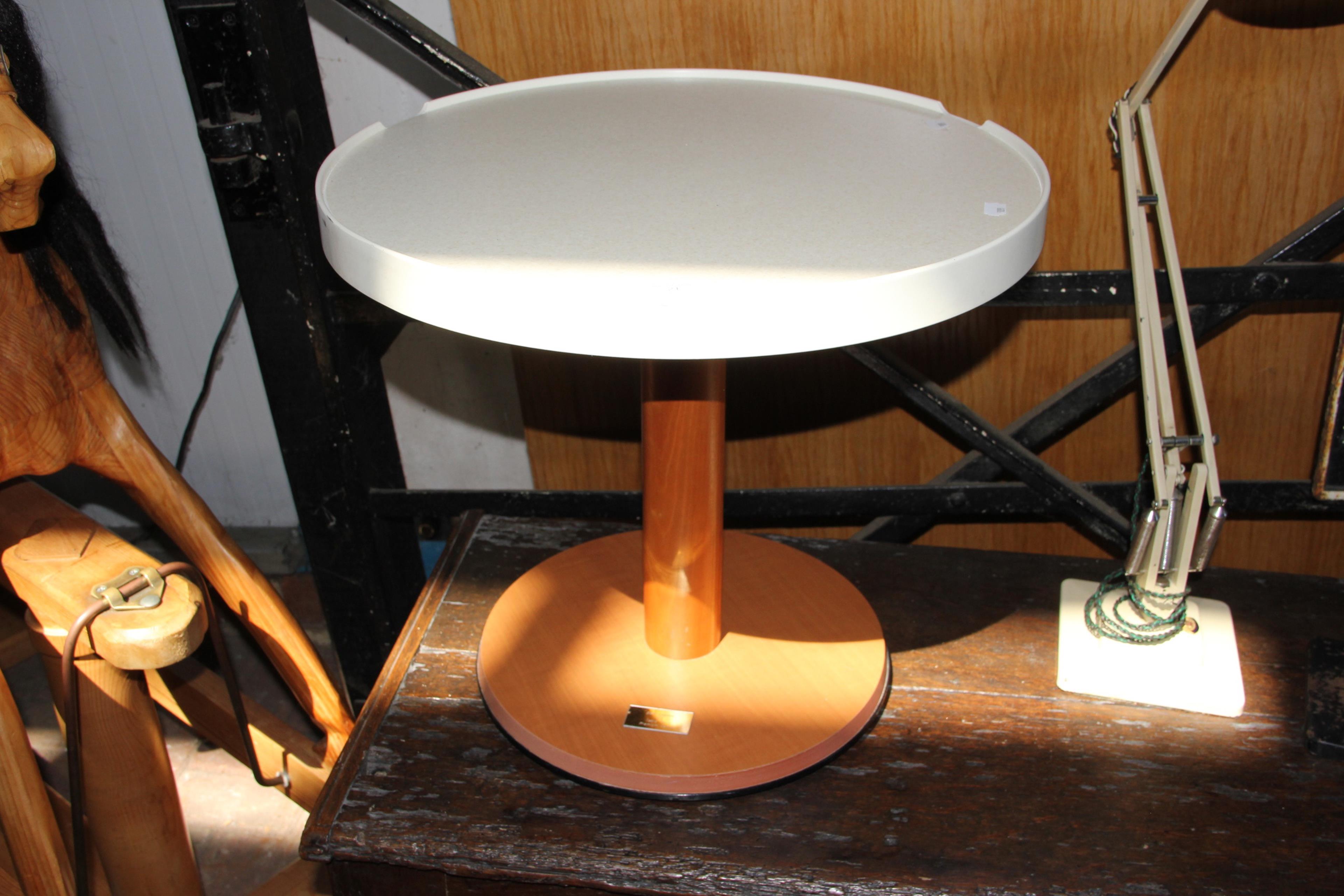 An original circular table from the QE2 with plaqu