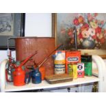 Assorted vintage oil cans, together with poster pa