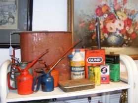 Assorted vintage oil cans, together with poster pa