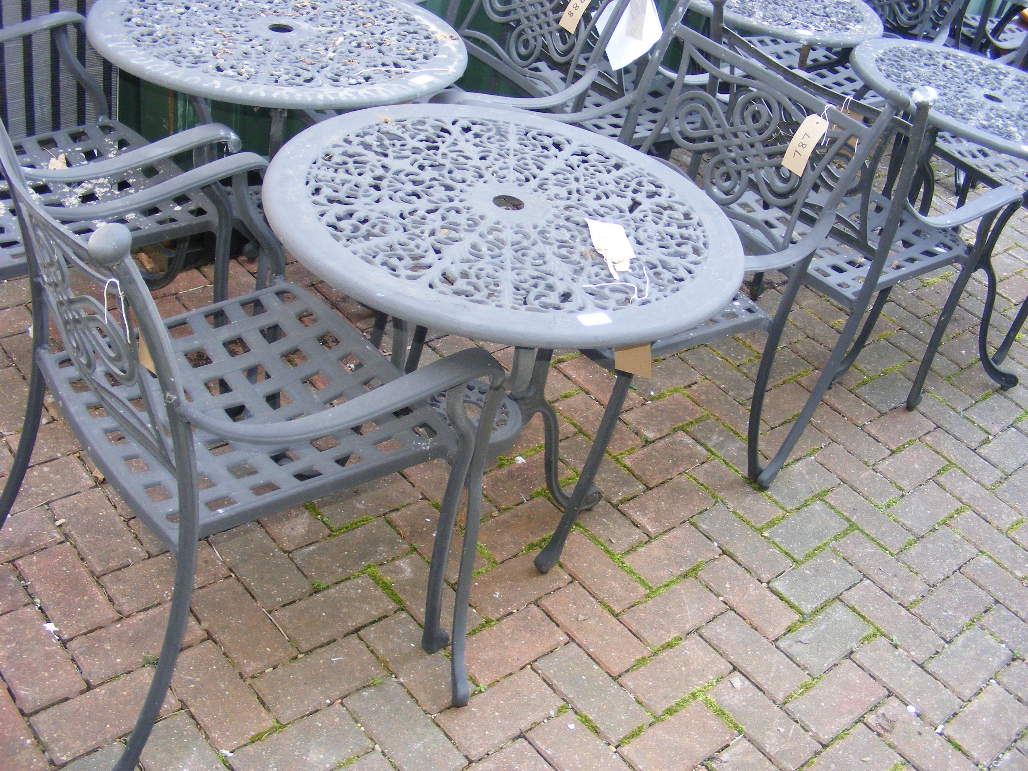 A black and metal bistro garden table with two cha