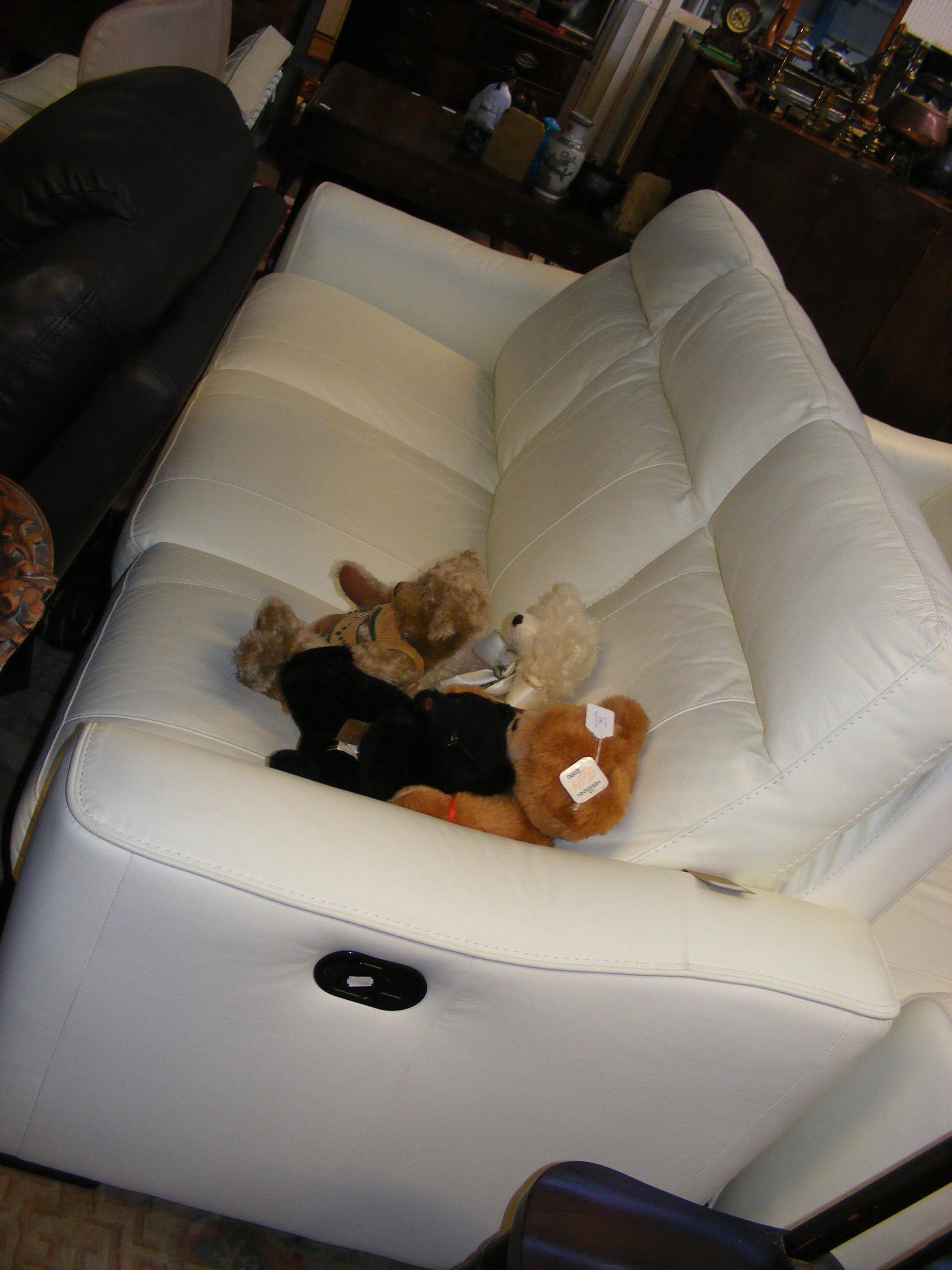 A modern three seater settee upholstered in white