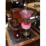 An antique oil lamp and one other