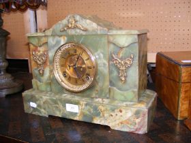 An antique onyx mantel clock with visible escapeme