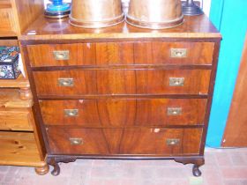 A walnut chest of four drawers with sunken brass handles