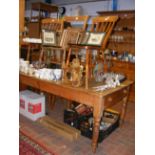 A pine farmhouse kitchen table with four chairs an