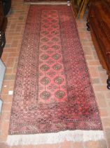 A Middle Eastern style runner with geometric borde