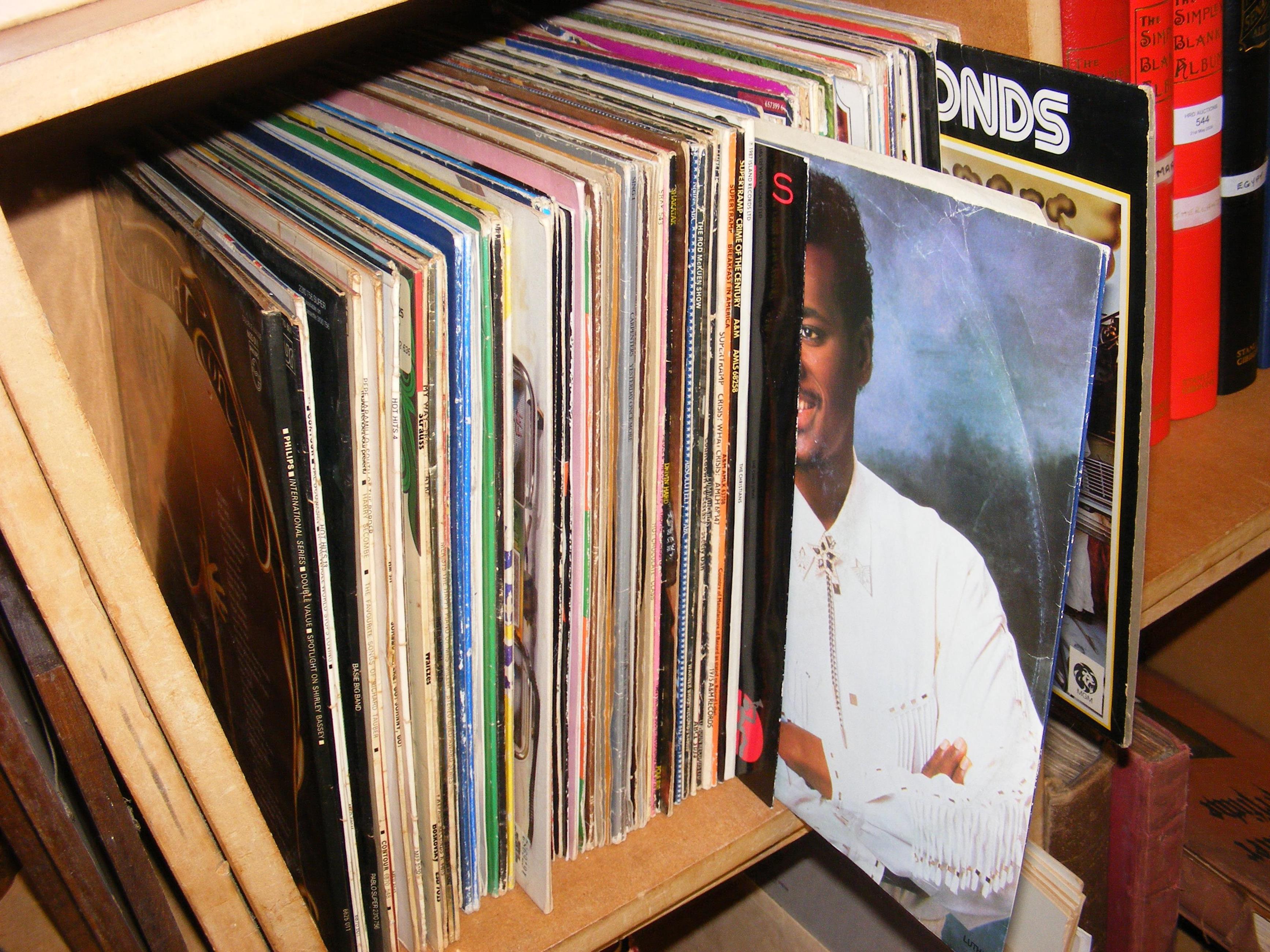A collection of vinyl LP records, including Supert