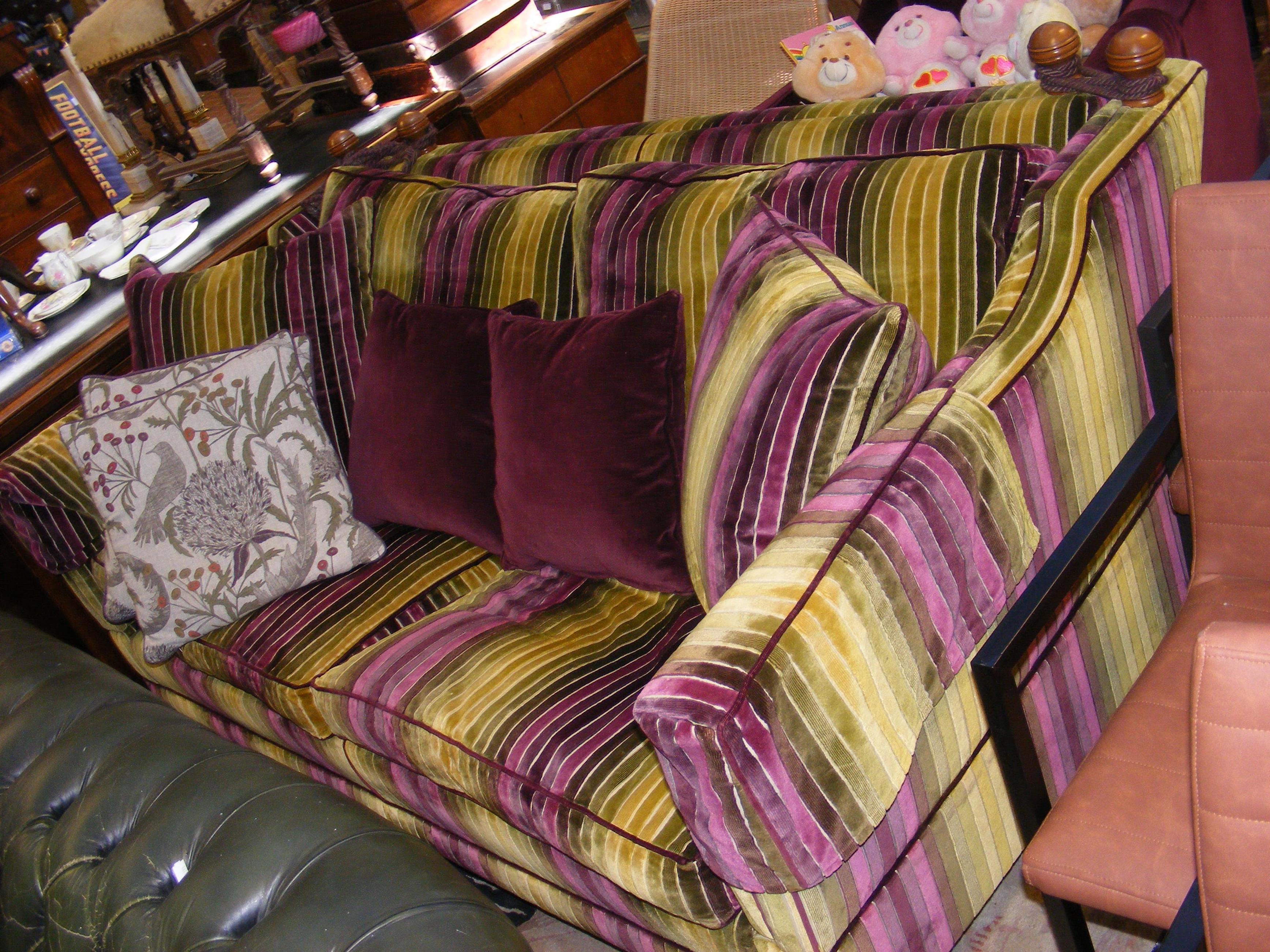 A modern Knoll style settee upholstered in stripe