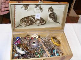 A wooden box containing costume jewellery includin