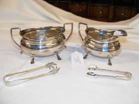 A silver cream and sugar bowl