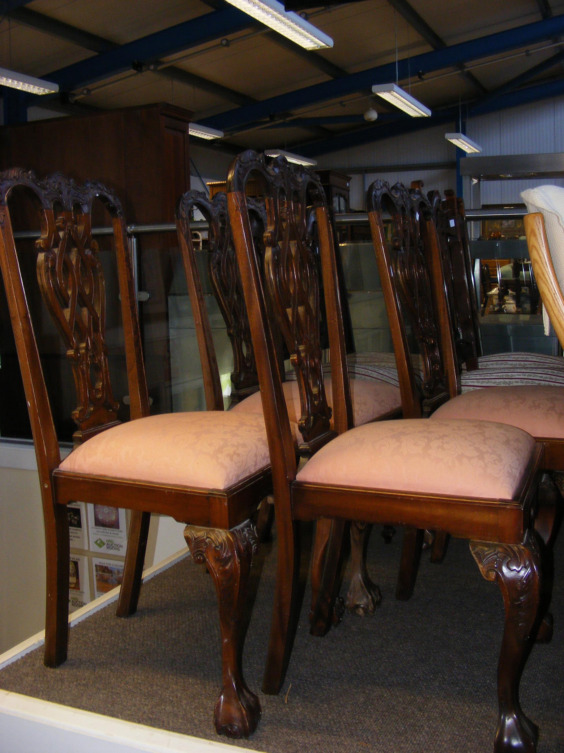 A set of four dining chairs with harp back detail