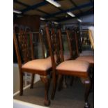 A set of four dining chairs with harp back detail