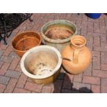 Four garden pots of varying shape and size