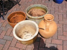 Four garden pots of varying shape and size