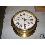 A brass cased ships baulk head clock by Pierre Deg