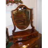 An antique toilet mirror with three drawers to the