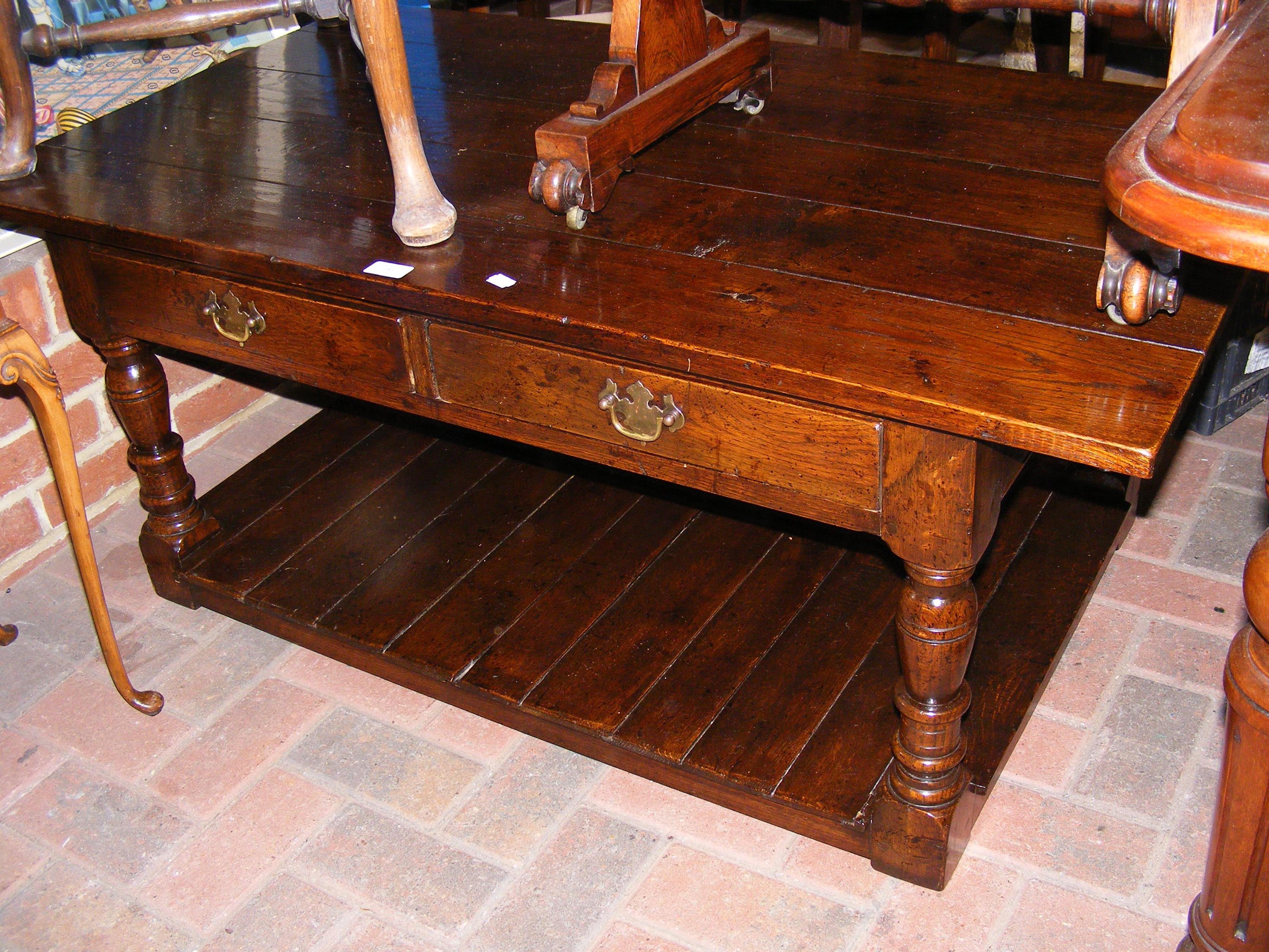 A quality oak two tier coffee table with drawer to