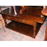 A quality oak two tier coffee table with drawer to