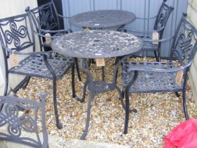 A black and metal bistro garden table with two cha