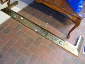An Arts & Crafts brass fire curb with Ruskin style
