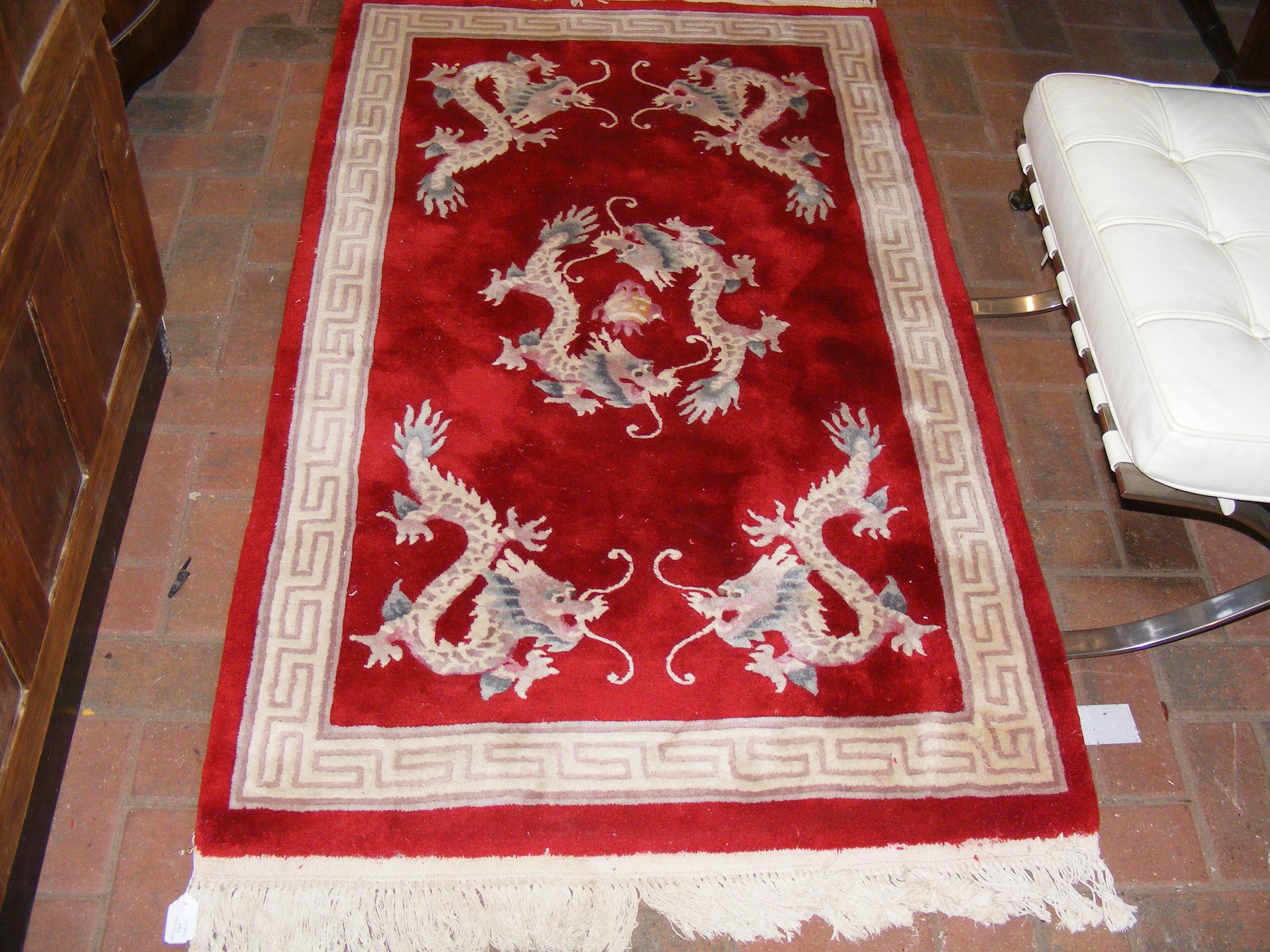 A small red Chinese rug with dragon design - 160cm