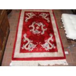 A small red Chinese rug with dragon design - 160cm
