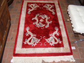 A small red Chinese rug with dragon design - 160cm