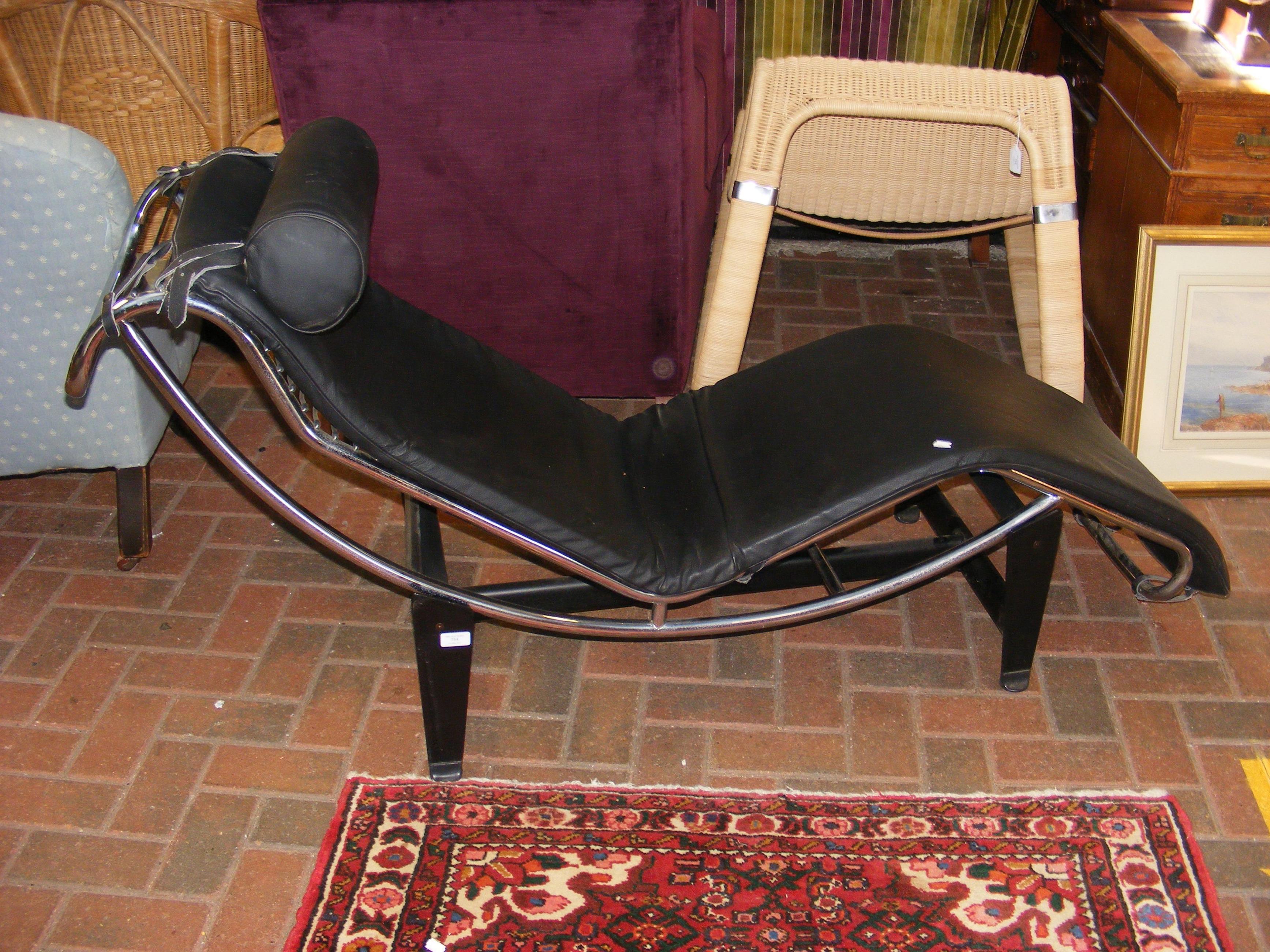 A retro chrome and black leatherette lounge reclin